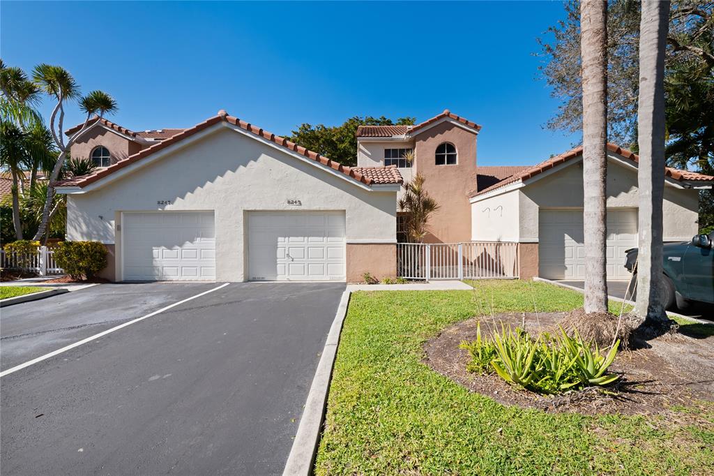 8245 Northwest 70th Street Tamarac, FL 33321 - Photo 15 of 29 a front view of a house with garden