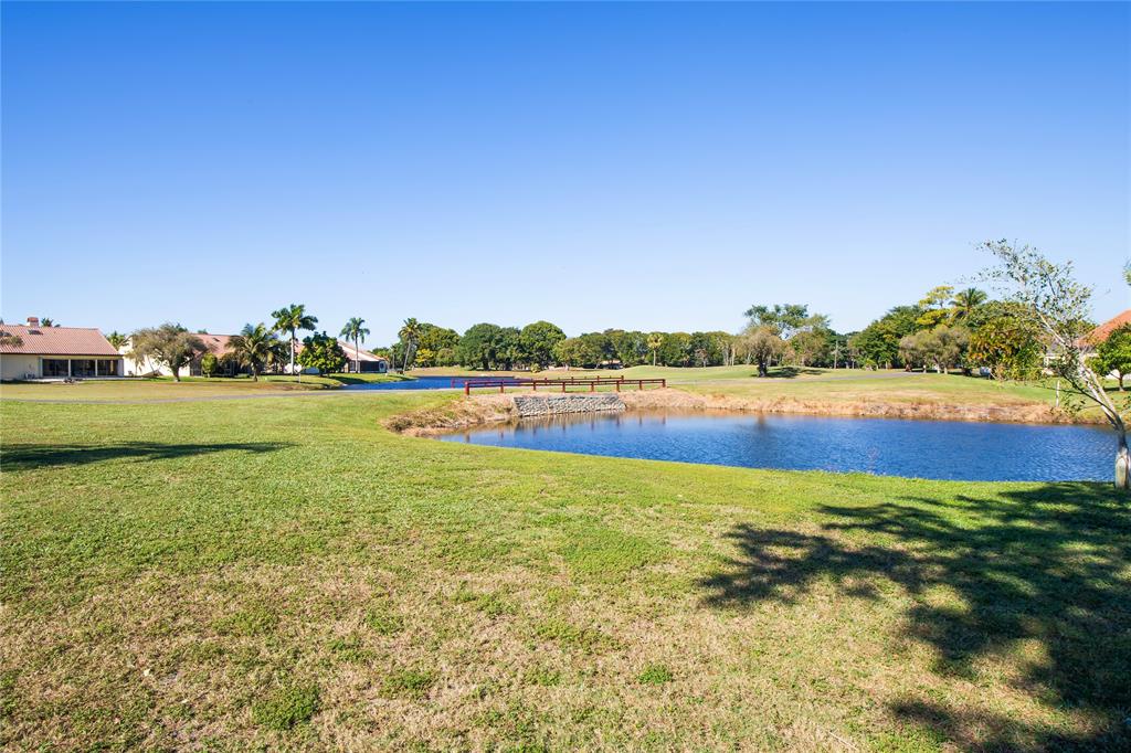 8245 Northwest 70th Street Tamarac, FL 33321 - Photo 17 of 29 a view of a green field with lawn chairs