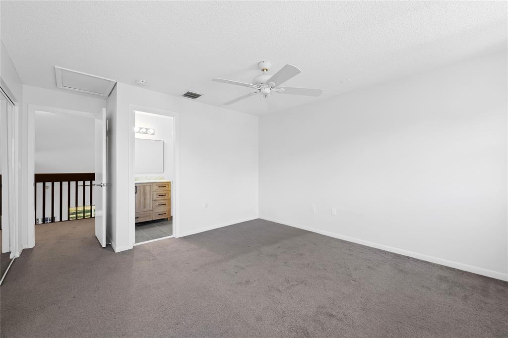 8245 Northwest 70th Street Tamarac, FL 33321 - Photo 22 of 29 an empty room with a ceiling fan and a window
