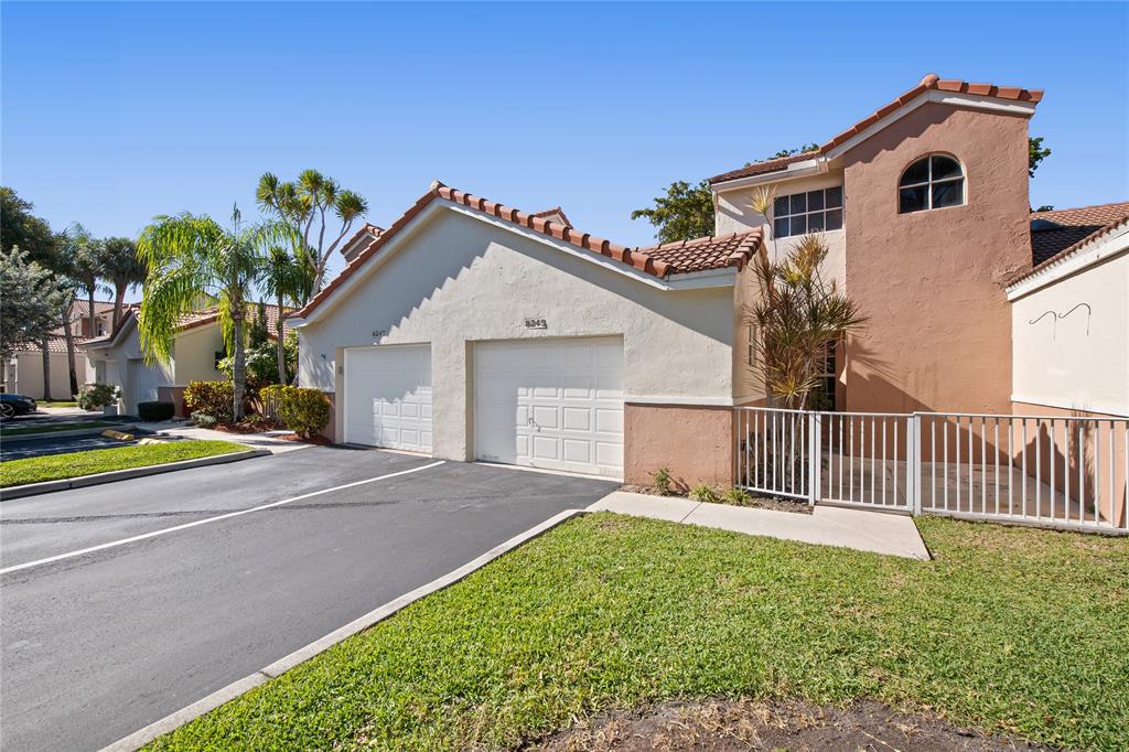 8245 Northwest 70th Street Tamarac, FL 33321 - Photo 25 of 29 a view of a house with a yard and potted plants