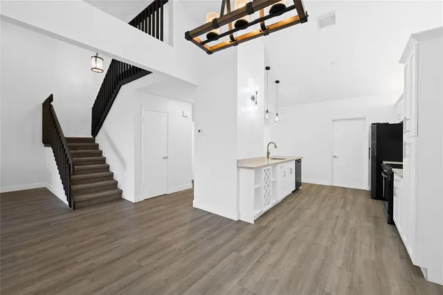 an empty room with wooden floor and white walls