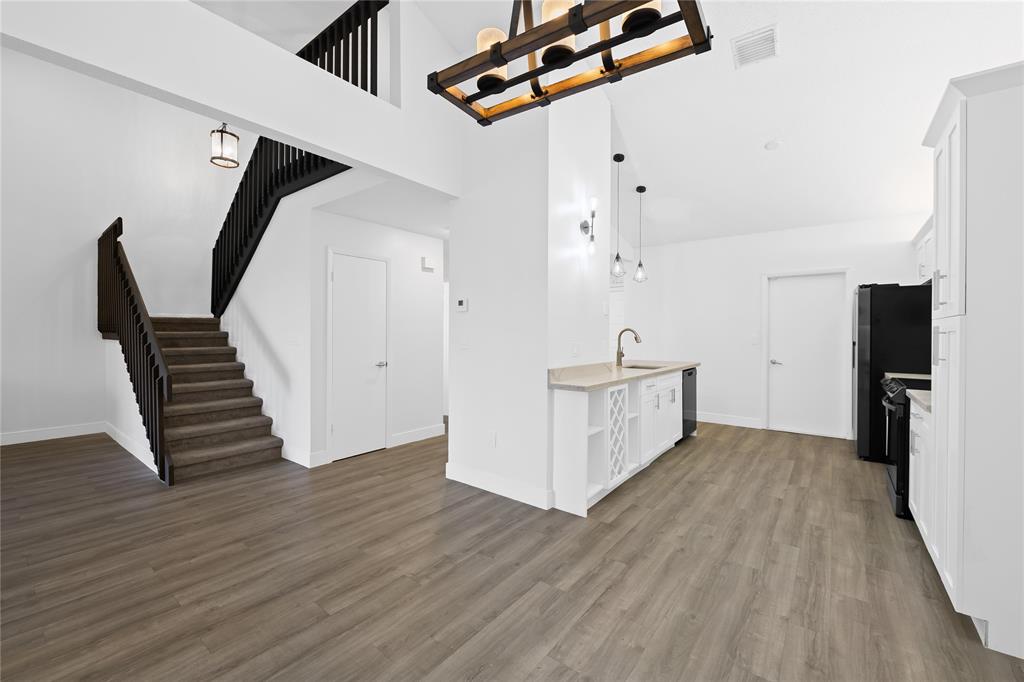 8245 Northwest 70th Street Tamarac, FL 33321 - Photo 8 of 29 an empty room with wooden floor and white walls