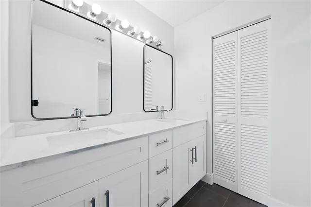 a bathroom with a double vanity sink and a mirror