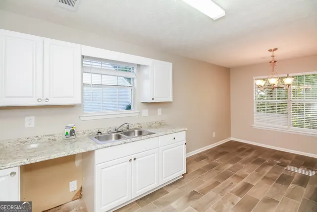 a kitchen with a sink stove and cabinets