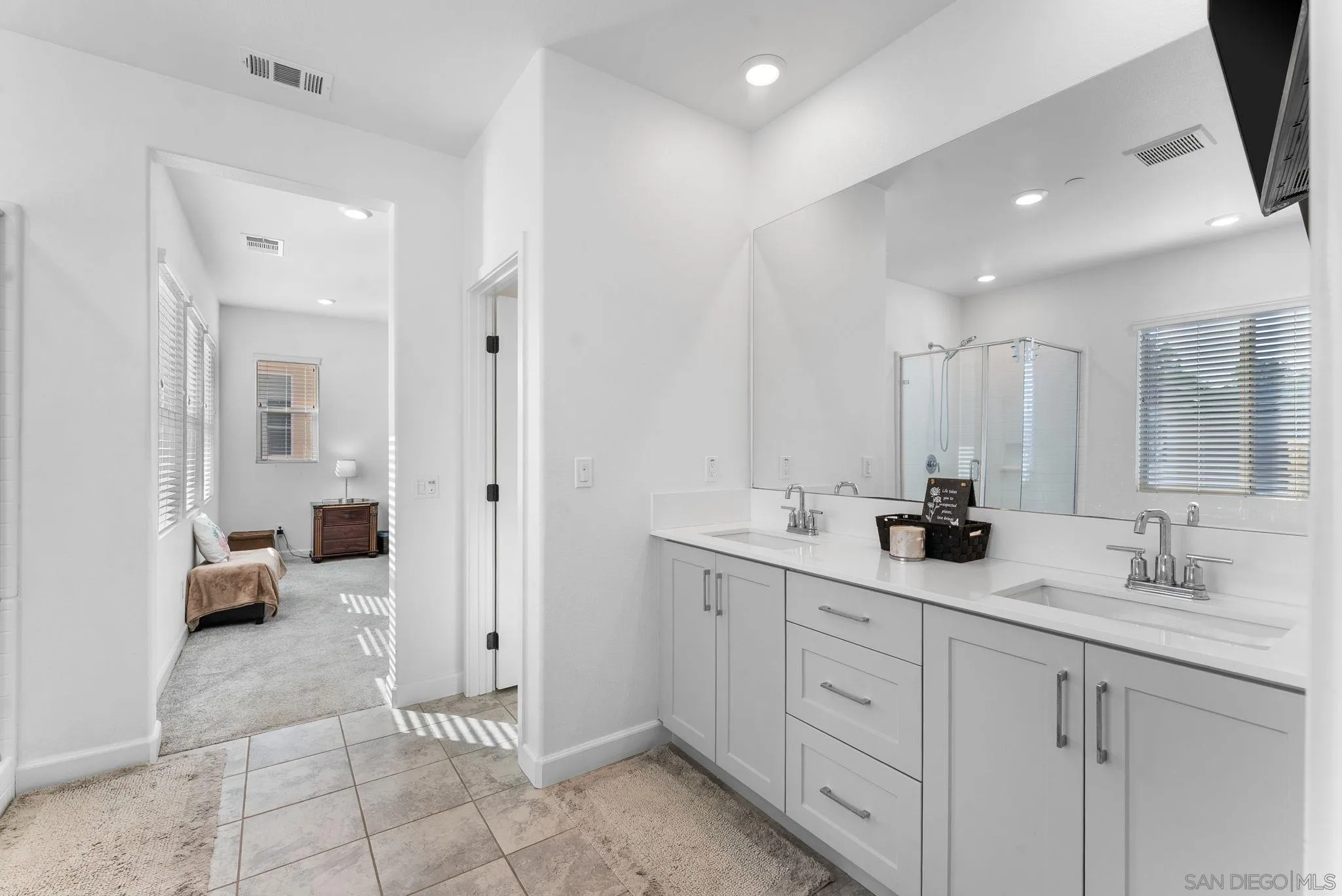 10129 Hercules Way Spring Valley, CA 91977 - Photo 18 of 52 a spacious bathroom with a double vanity sink and mirror