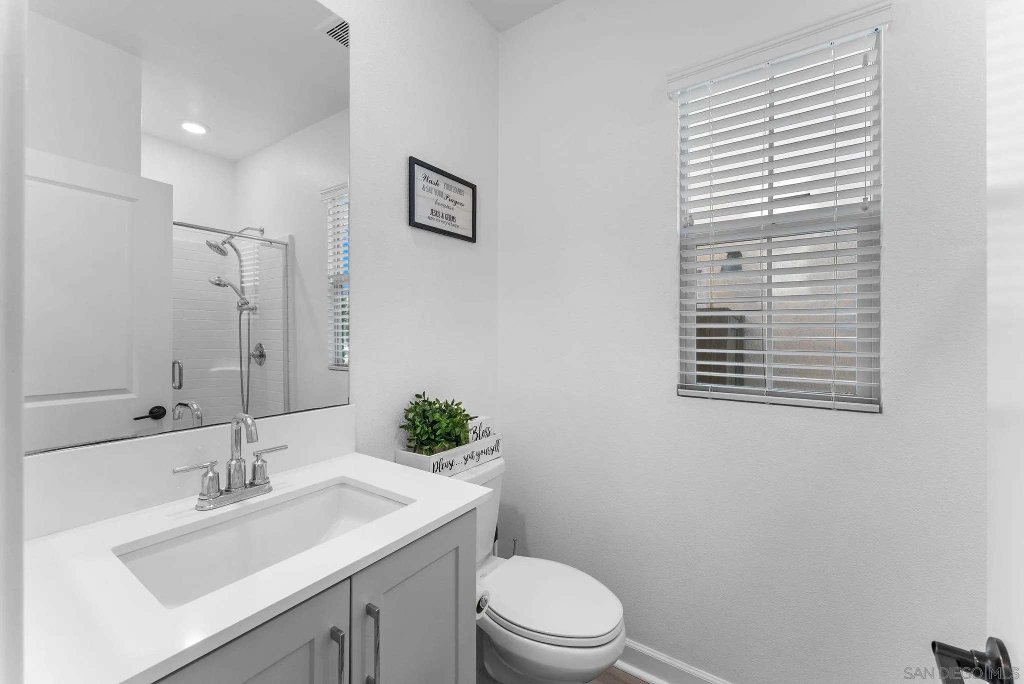 10129 Hercules Way Spring Valley, CA 91977 - Photo 25 of 52 a bathroom with a sink a toilet and mirror
