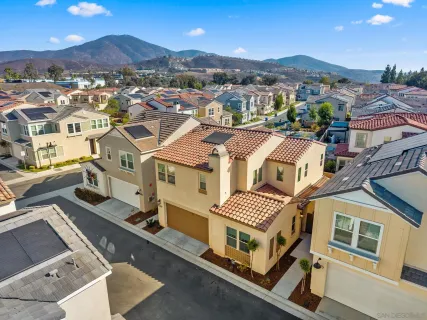an aerial view of a house with a mountain view