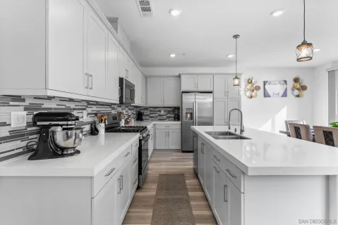 a kitchen with a sink stove and cabinets
