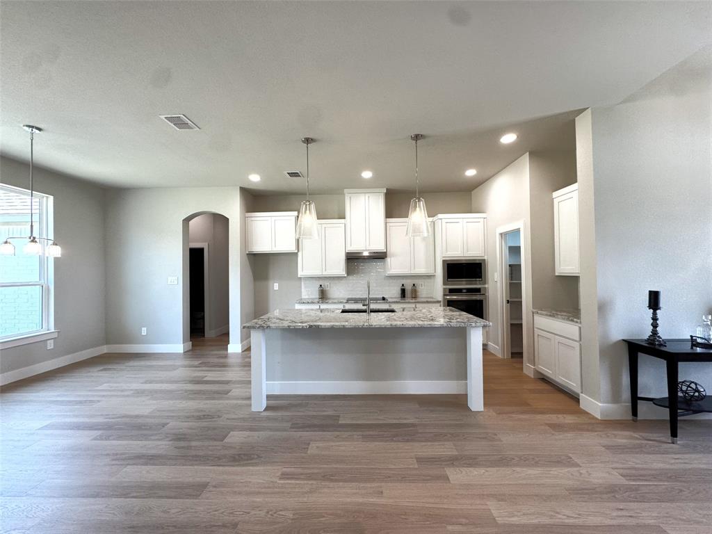1005 Ronnie Court Springtown, TX 76082 - Photo 9 of 27 Open-concept living space with wood-finish flooring