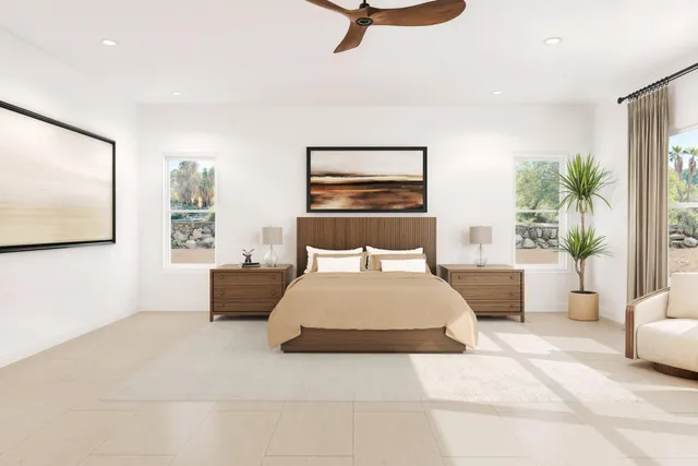 a bedroom with a large bed and a flat screen tv