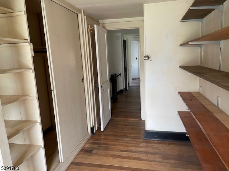 11 Creek Road Whitehouse Station, NJ 08889 - Photo 11 of 32 a view of a hallway with wooden floor and staircase