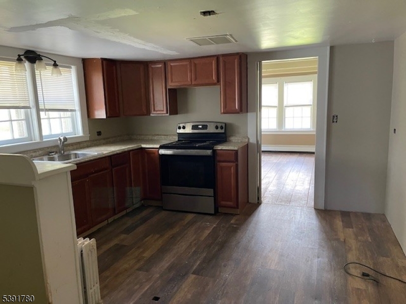 11 Creek Road Whitehouse Station, NJ 08889 - Photo 27 of 32 a kitchen with stainless steel appliances granite countertop a stove a sink and a refrigerator