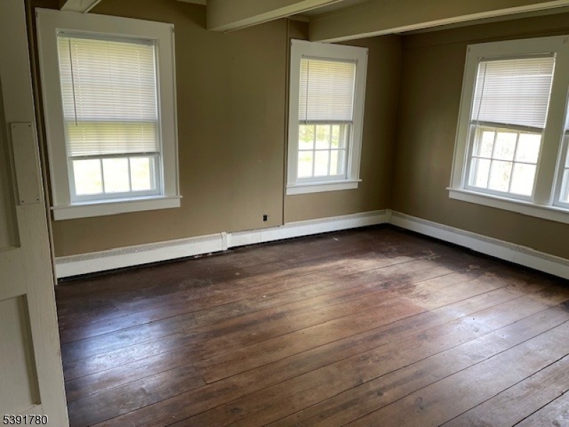 11 Creek Road Whitehouse Station, NJ 08889 - Photo 30 of 32 a view of an empty room with wooden floor and a window
