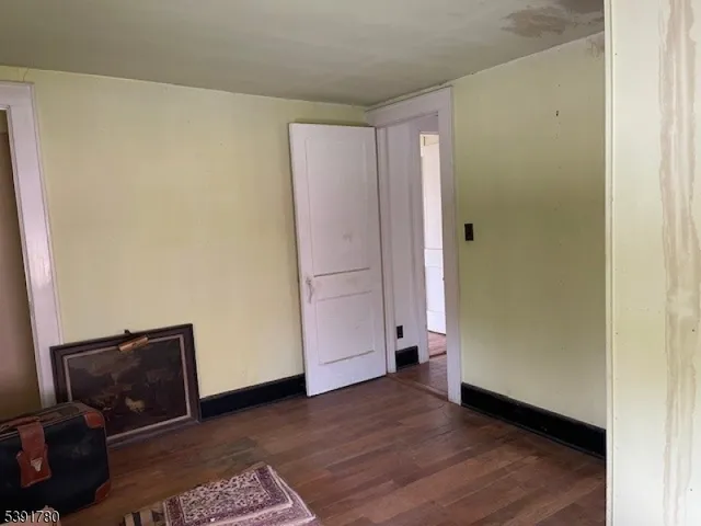 a view of an empty room and wooden floor