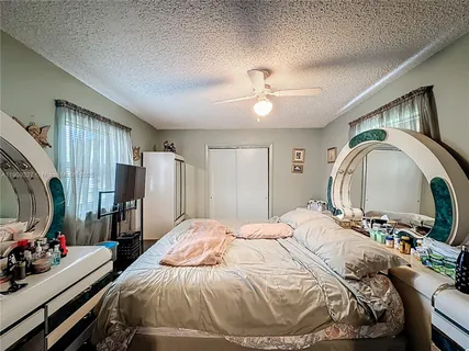 a bedroom with bed and a mirror