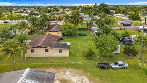a aerial view of a house with garden space and street view