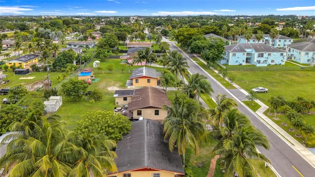 an aerial view of residential houses with outdoor space
