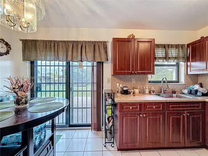 a kitchen with a stove a sink and a refrigerator