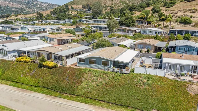 a aerial view of a house with swimming pool and ocean view