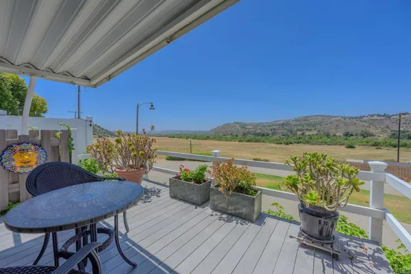 a view of a chairs and table in patio
