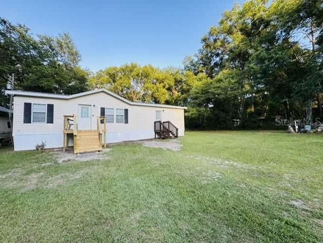 11817 Southwest 58th Street Webster, FL 33597 - Photo 29 of 46 a view of a house with backyard and a tree