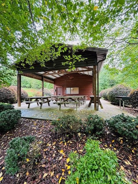196 Moriah Drive Rutherfordton, NC 28139 - Photo 40 of 48 a backyard of a house with table and chairs under an umbrella