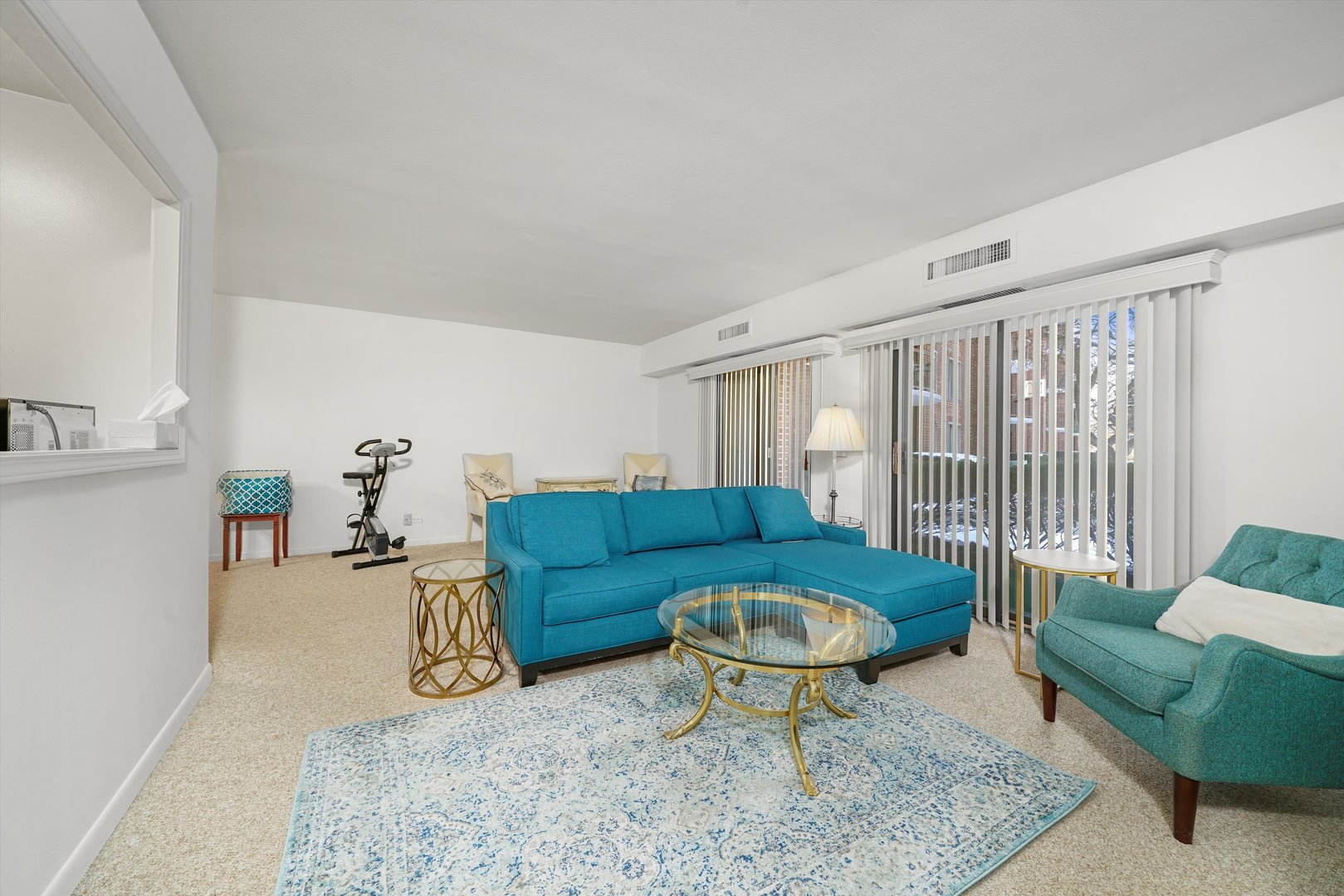 1405 East Central Road, Unit 110B Arlington Heights, IL 60005 - Photo 11 of 33 a living room with furniture a rug and a table
