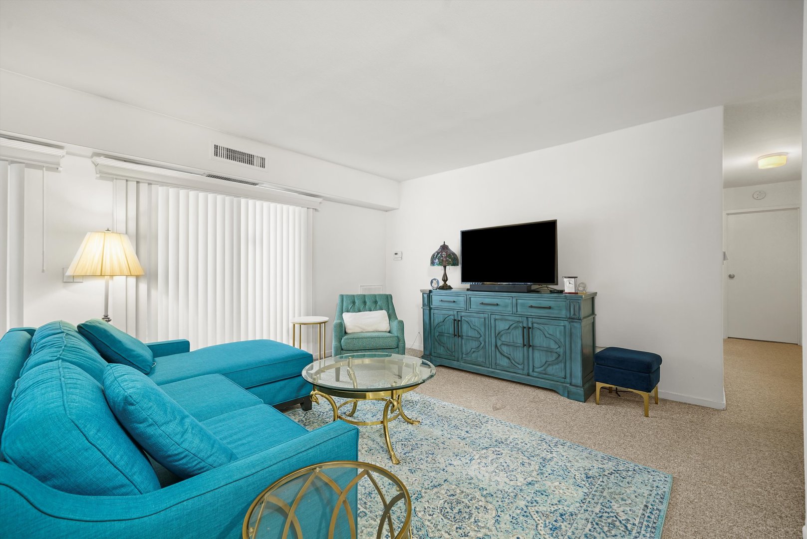 1405 East Central Road, Unit 110B Arlington Heights, IL 60005 - Photo 13 of 33 a living room with furniture and a flat screen tv