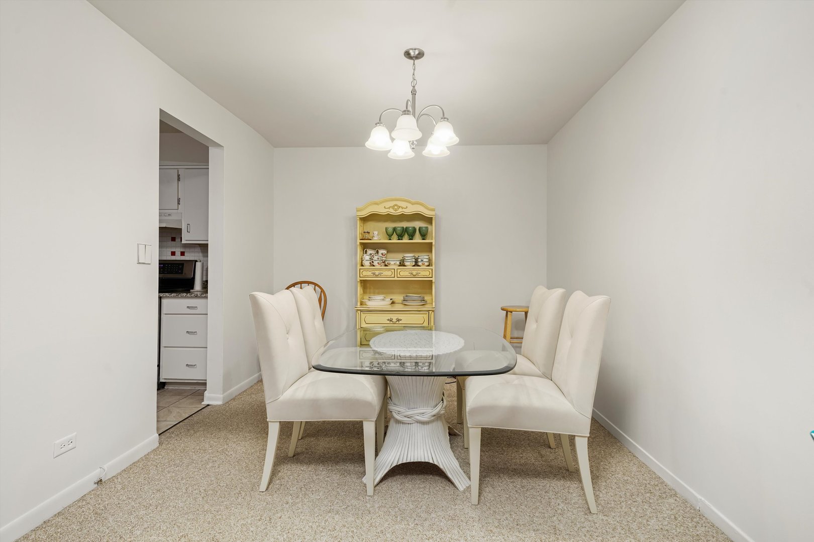 1405 East Central Road, Unit 110B Arlington Heights, IL 60005 - Photo 15 of 33 a view of a dining room with furniture and chandelier
