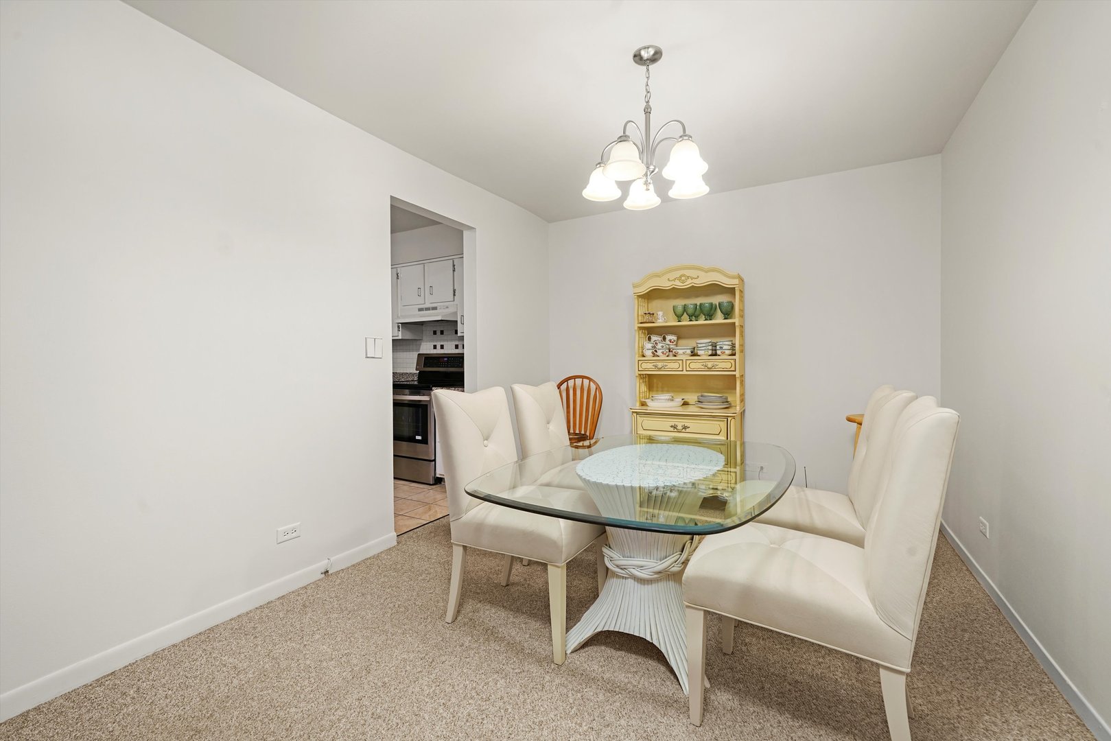 1405 East Central Road, Unit 110B Arlington Heights, IL 60005 - Photo 16 of 33 a view of a dining room with furniture and chandelier