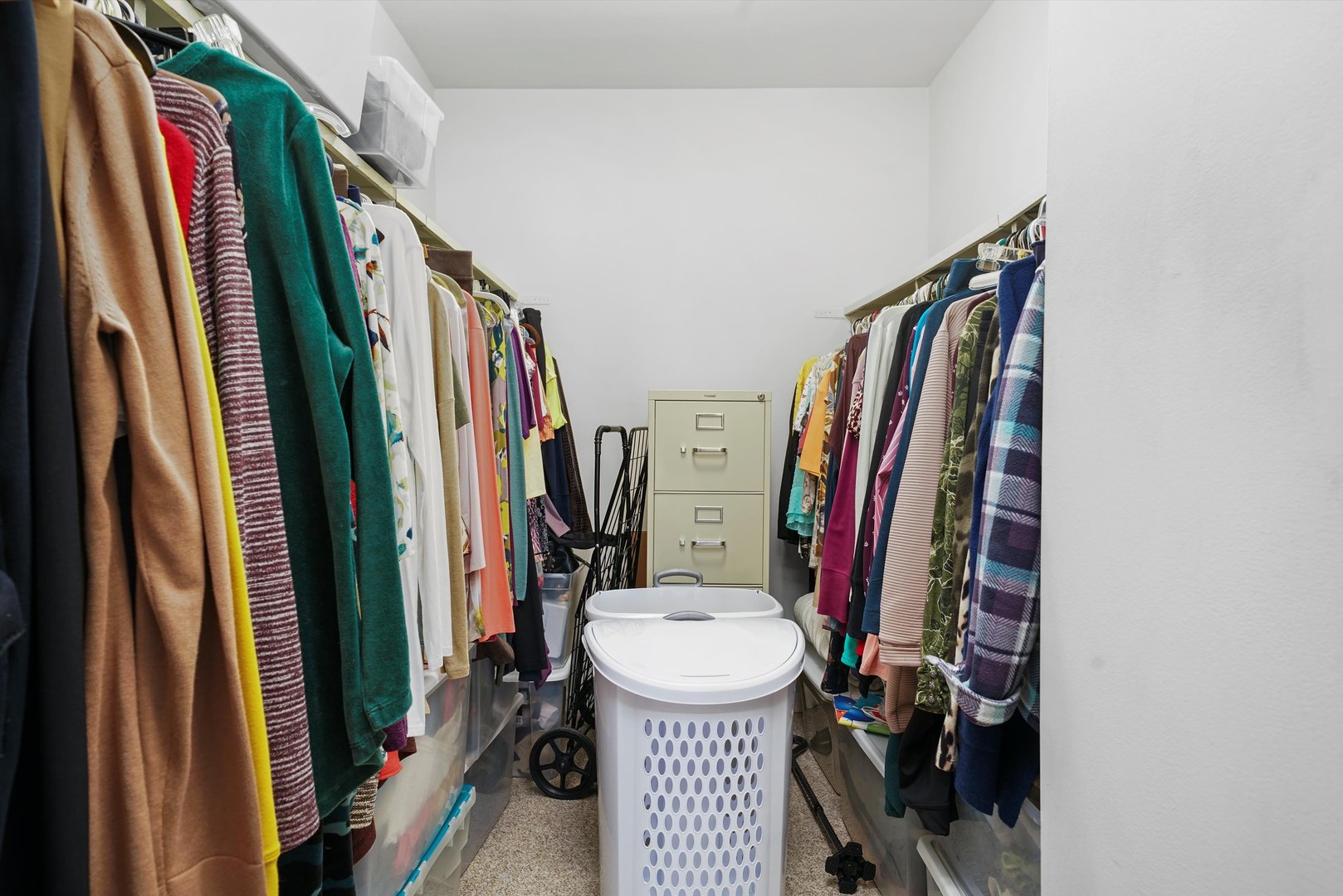1405 East Central Road, Unit 110B Arlington Heights, IL 60005 - Photo 19 of 33 a view of a walk in closet with clothes and shoes