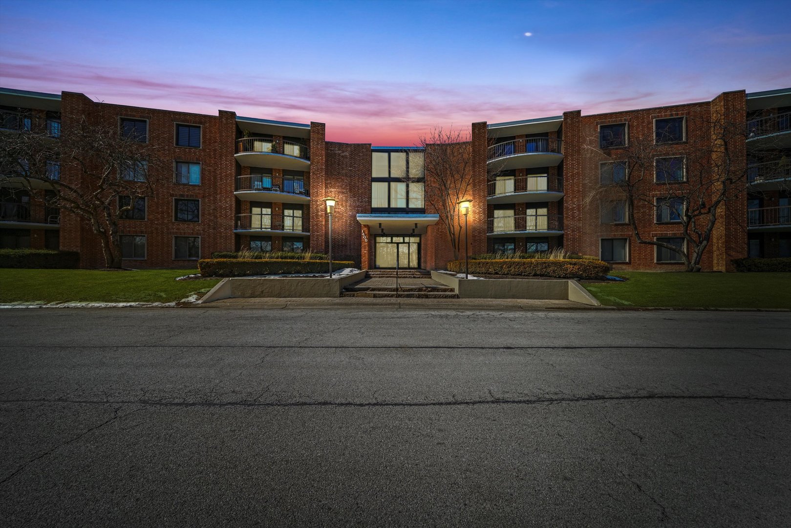1405 East Central Road, Unit 110B Arlington Heights, IL 60005 - Photo 2 of 33 a front view of residential houses with street