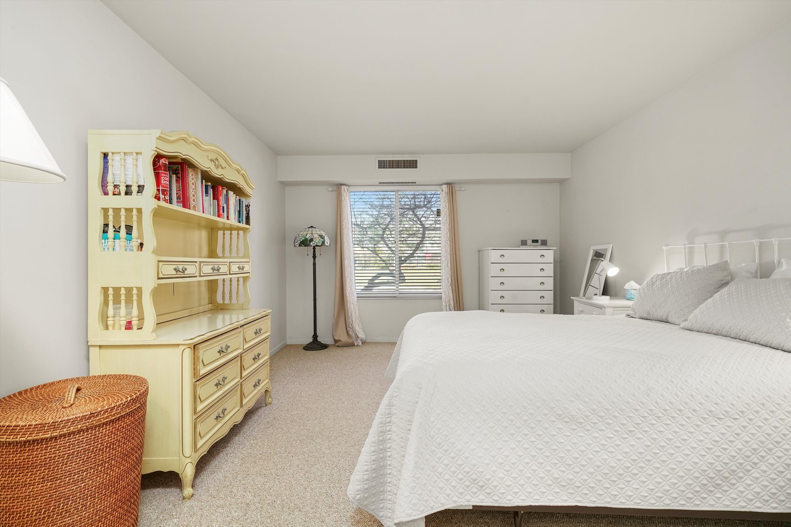 1405 East Central Road, Unit 110B Arlington Heights, IL 60005 - Photo 21 of 33 a spacious bedroom with a bed a dresser and large window