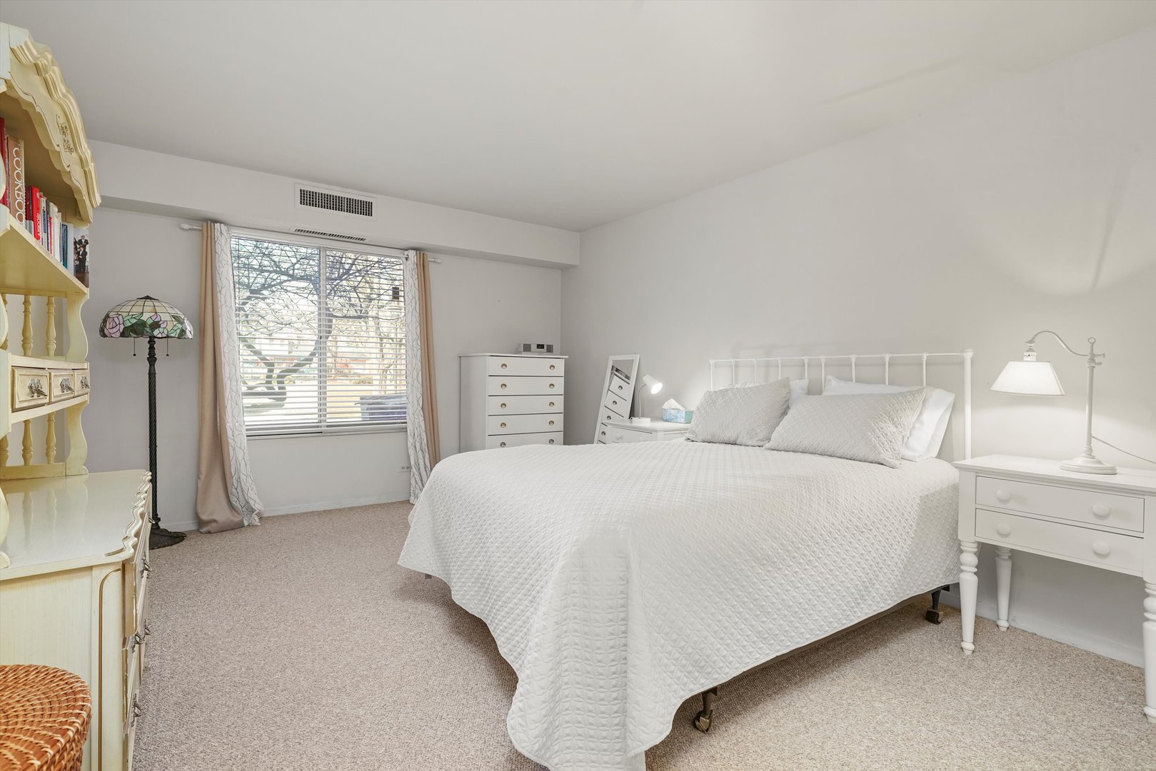 1405 East Central Road, Unit 110B Arlington Heights, IL 60005 - Photo 22 of 33 a bedroom with a bed and a window