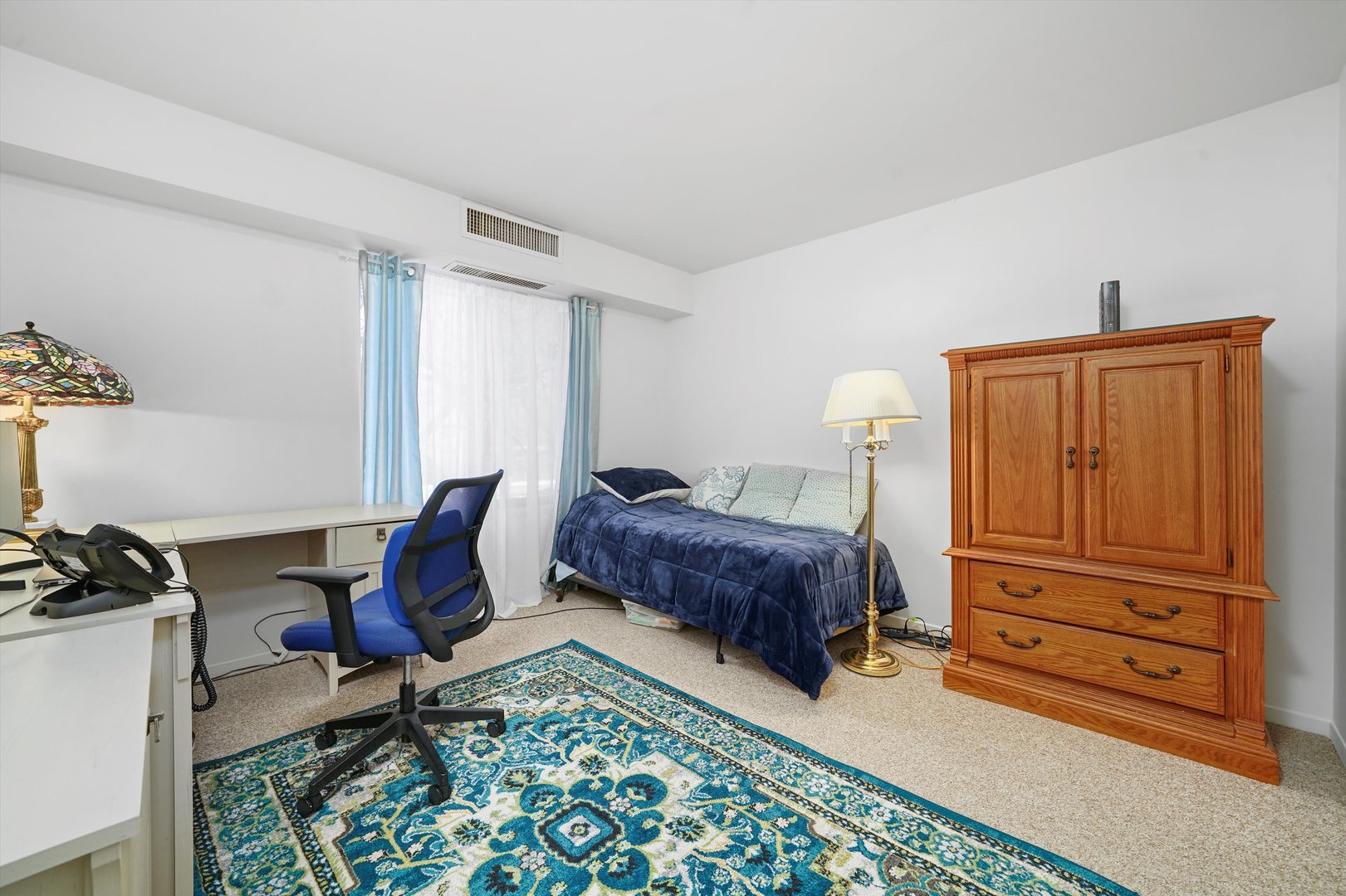 1405 East Central Road, Unit 110B Arlington Heights, IL 60005 - Photo 24 of 33 a bedroom with a bed and furniture