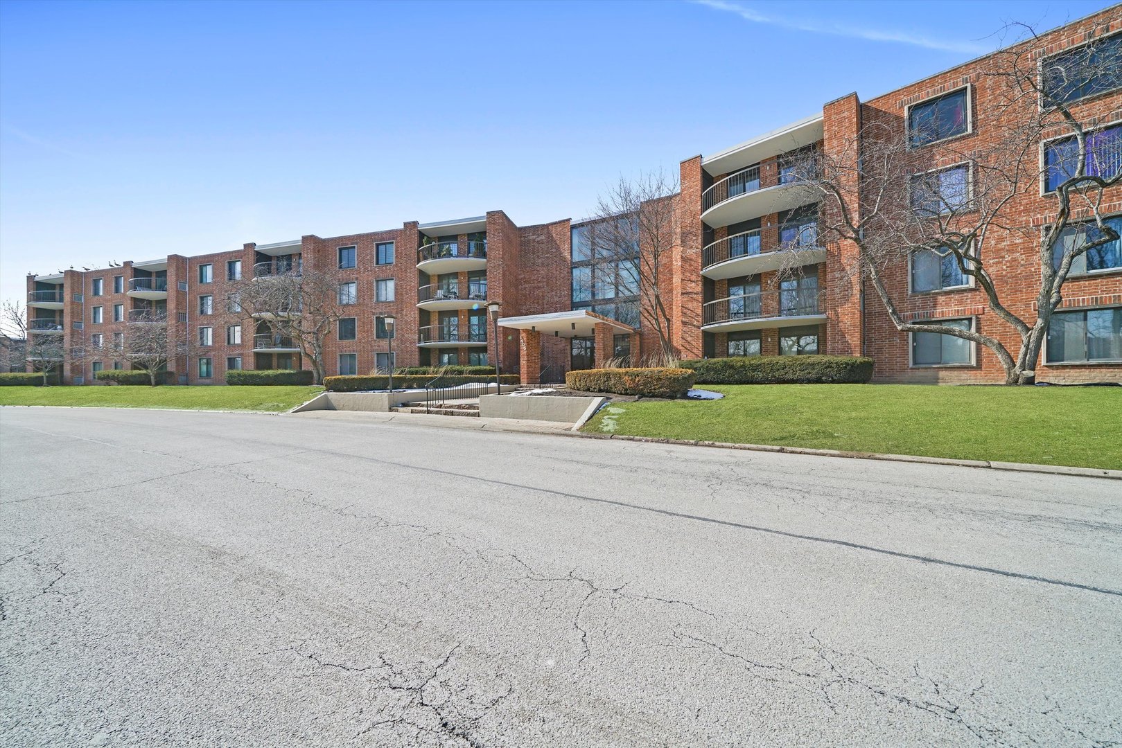 1405 East Central Road, Unit 110B Arlington Heights, IL 60005 - Photo 29 of 33 a view of buildings with yard