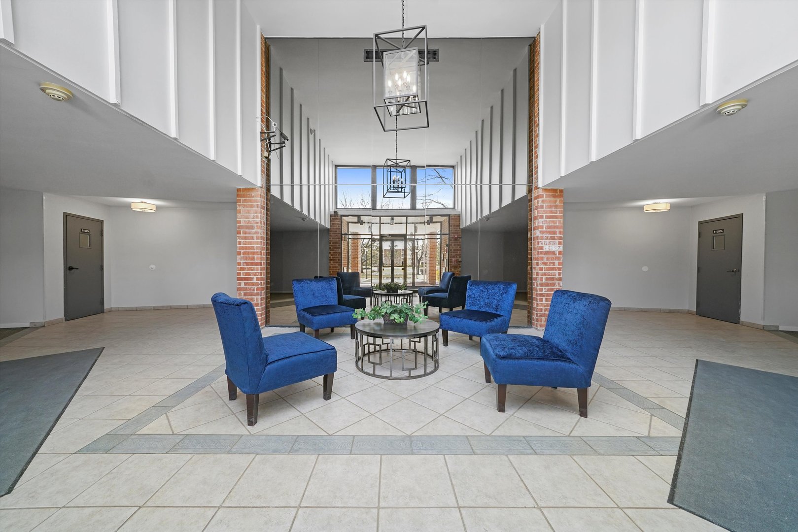 1405 East Central Road, Unit 110B Arlington Heights, IL 60005 - Photo 3 of 33 a view of a livingroom with furniture and a chandelier