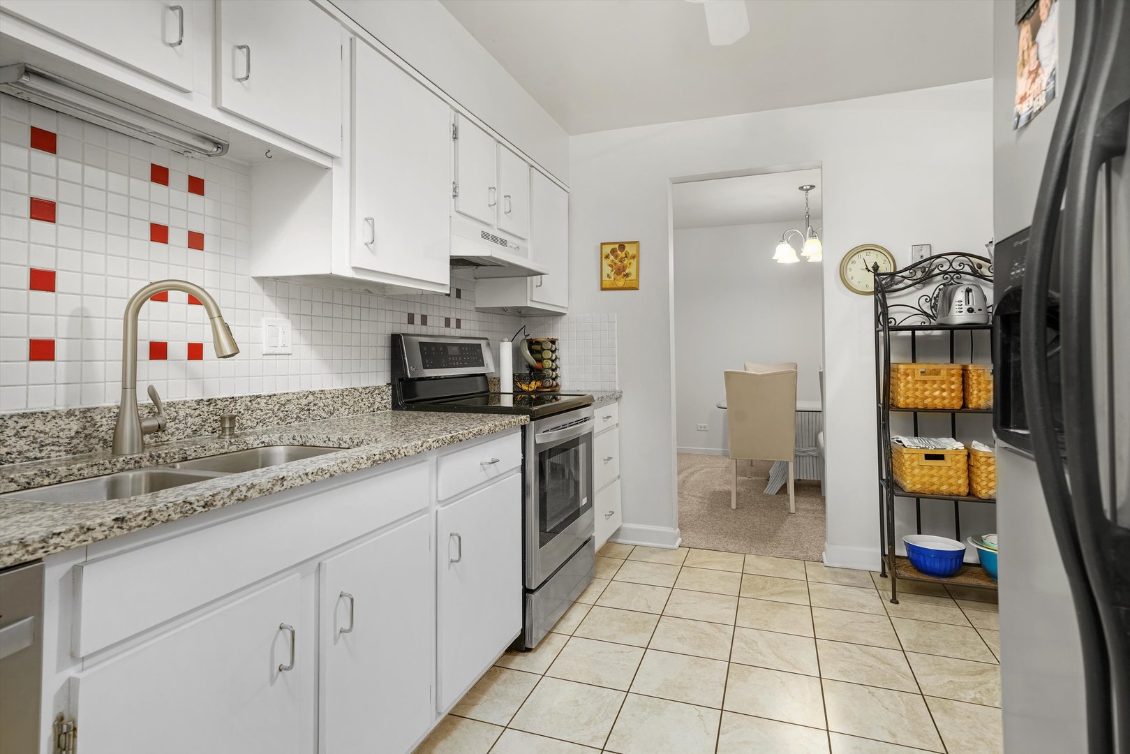 1405 East Central Road, Unit 110B Arlington Heights, IL 60005 - Photo 8 of 33 a kitchen with a sink a stove and cabinets
