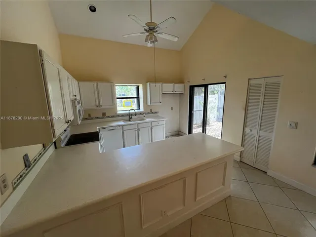 a kitchen with cabinets and wooden floor