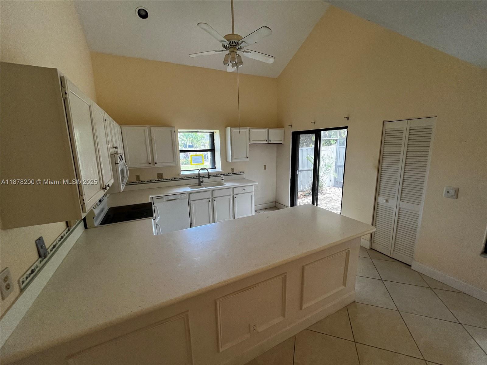 601 Summerwinds Lane Jupiter, FL 33458 - Photo 16 of 41 a kitchen with cabinets and wooden floor