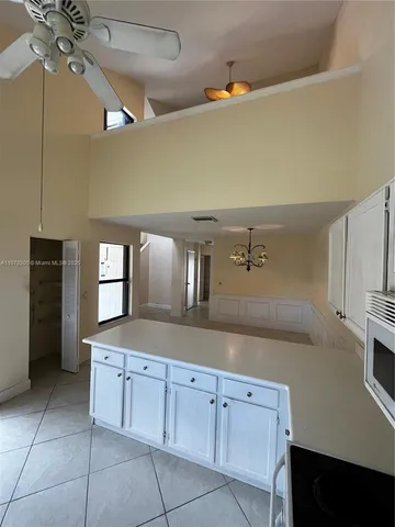 a kitchen with cabinets and window