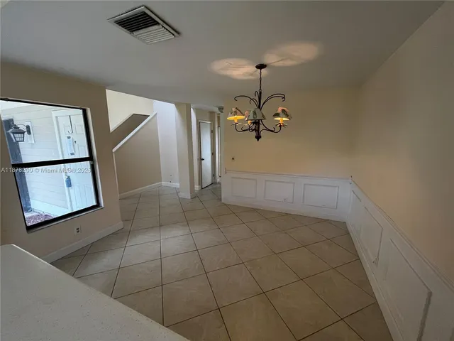 a view of a livingroom with furniture and chandelier fan
