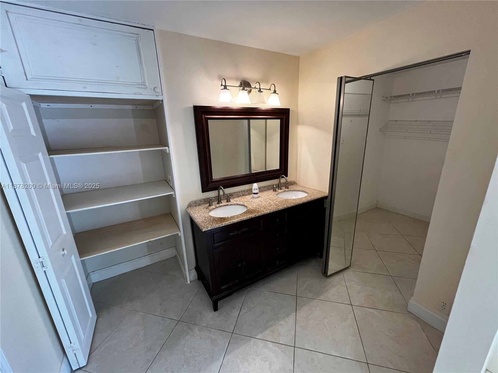 601 Summerwinds Lane Jupiter, FL 33458 - Photo 27 of 41 a kitchen with a refrigerator and a stove top oven