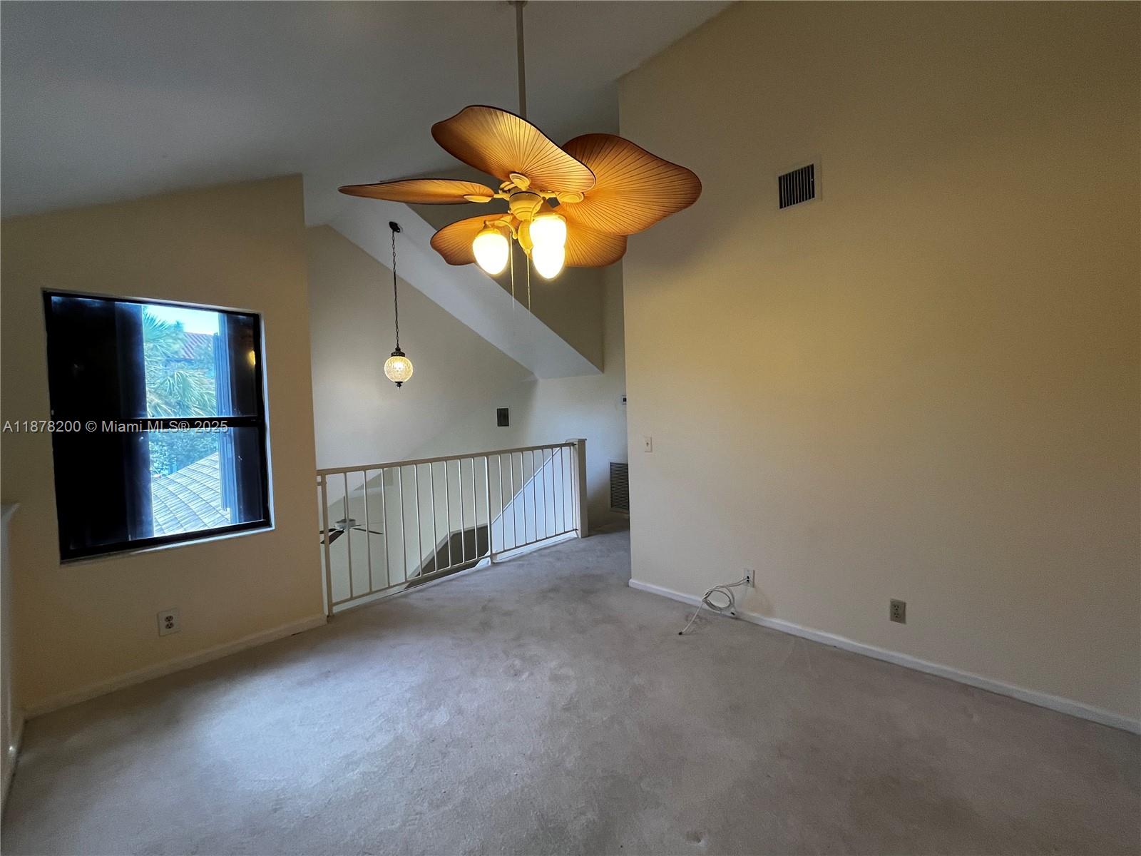 601 Summerwinds Lane Jupiter, FL 33458 - Photo 30 of 41 an empty room with windows and fan