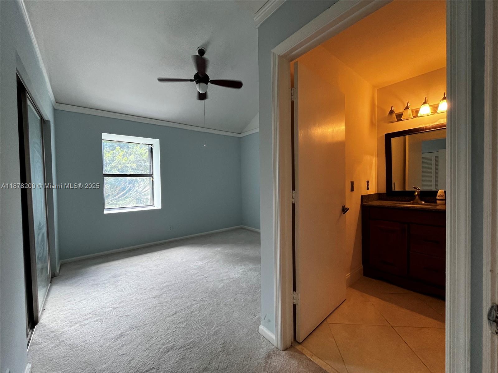 601 Summerwinds Lane Jupiter, FL 33458 - Photo 32 of 41 a view of hallway with a large window and chandelier