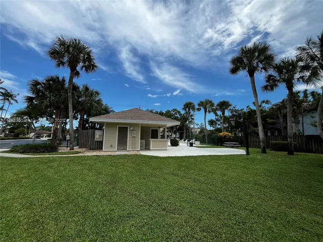 a view of a house with a backyard porch and sitting area