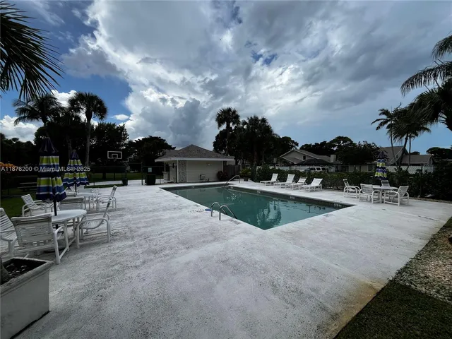a view of outdoor space with cars parked