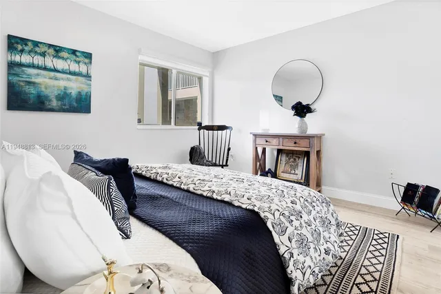 a kitchen with stainless steel appliances granite countertop white cabinets and a refrigerator