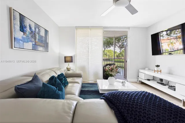 a living room with furniture and a wooden floor