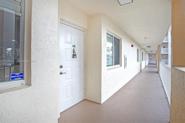 a dining room with furniture and a floor to ceiling window